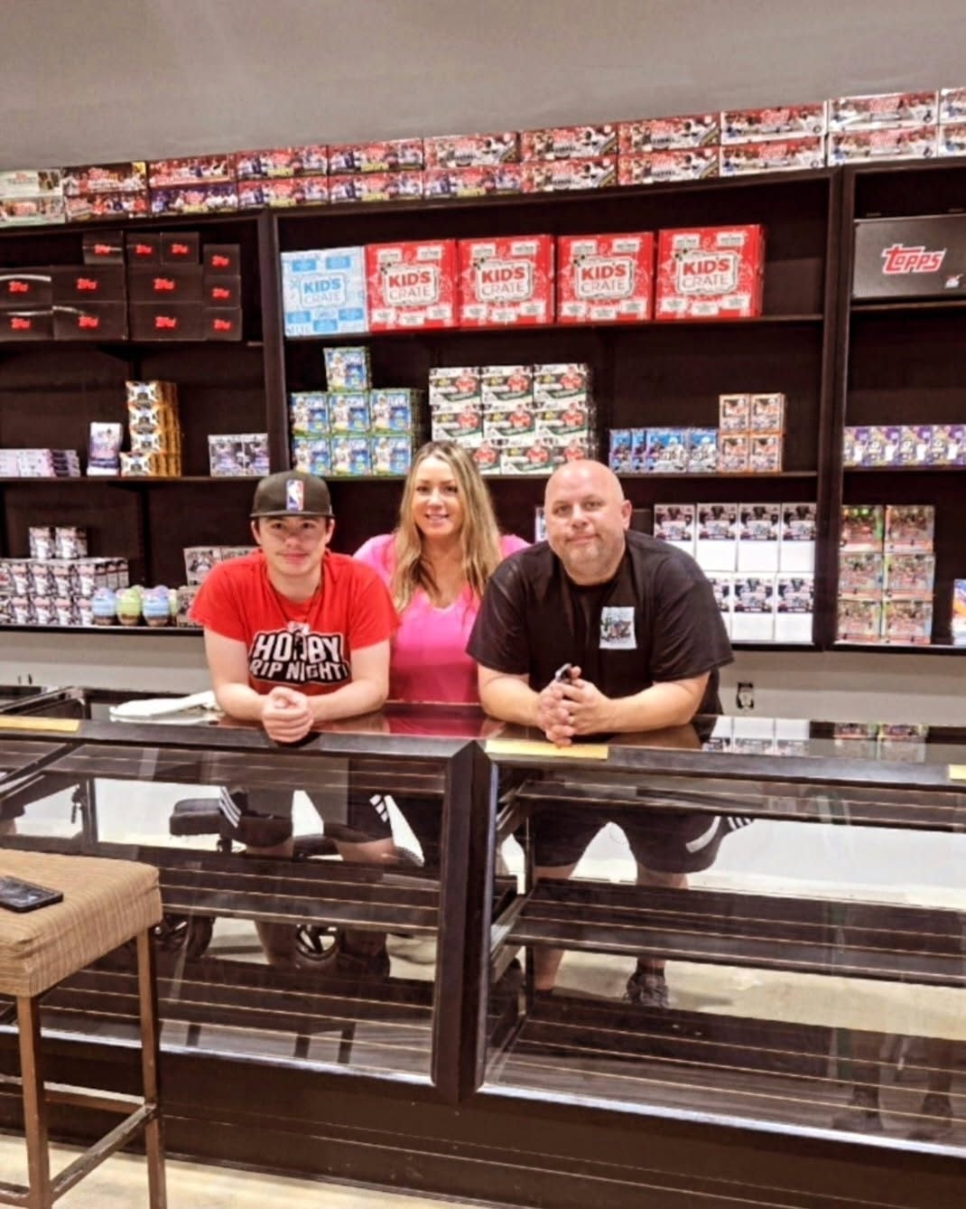 The owners of Hot Corner Sports Cards inside their shop